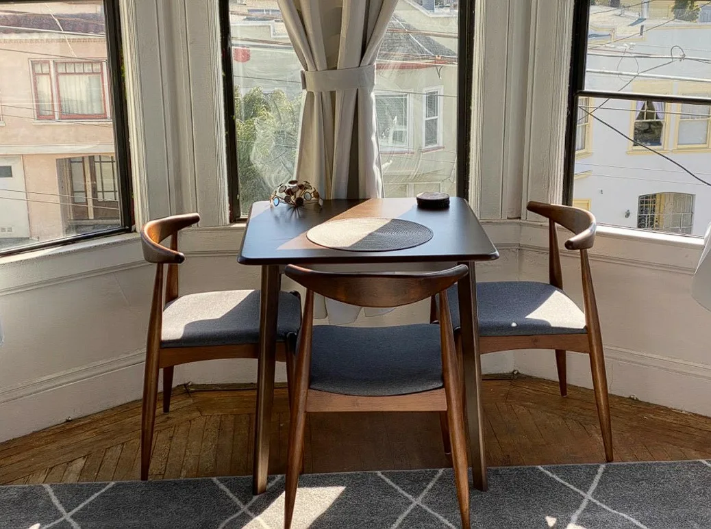 36 Inch Square Dinner Table Brown Varnished Round Edges With Matching Chairs And Window View