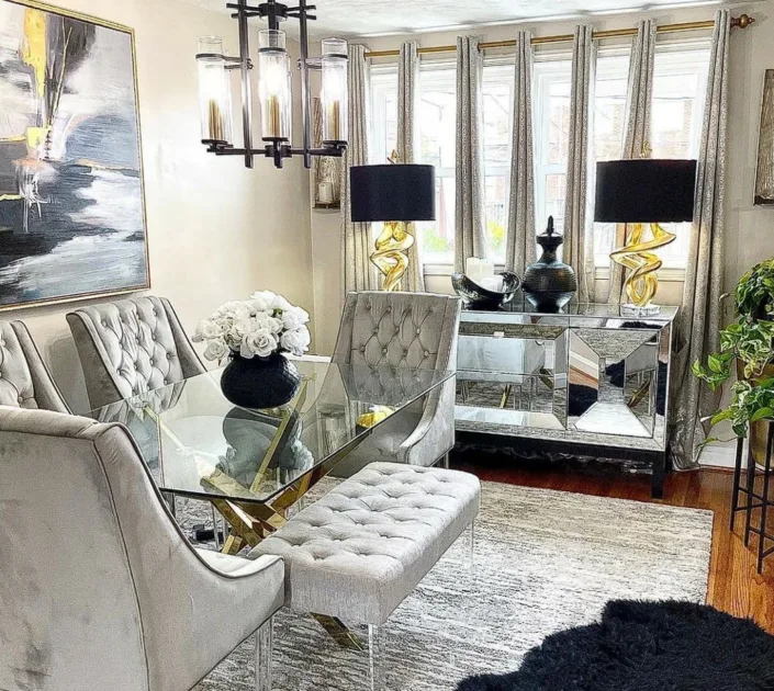 Glass Dinner Table Glass Top With Geometric Gold Base And Silver Cusioned Chairs