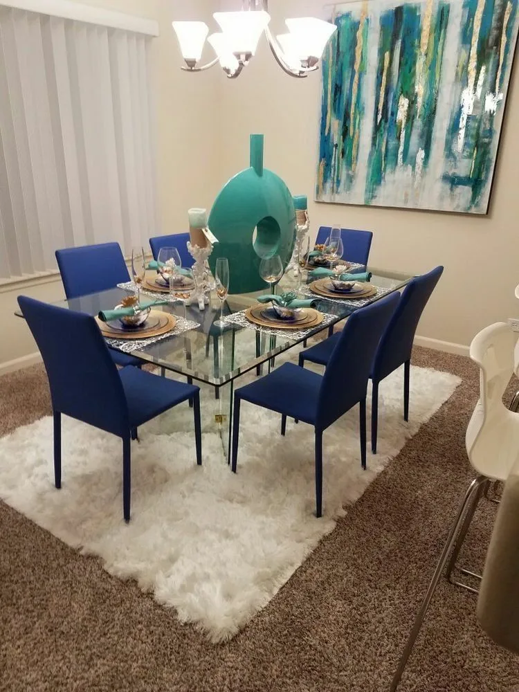 Glass Dinner Table With Clear Fiber Glass Base And Decorative Centerpiece