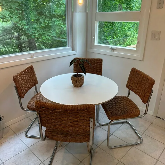 Modern Dinner Table White Round Wood Top And Rattan Weaved And Metal Chairs