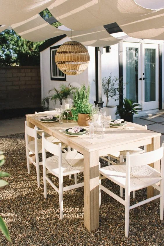 Outdoor Dinner Wood Table Backyard Dining Area With Drapes And Hanging Rattan Ball