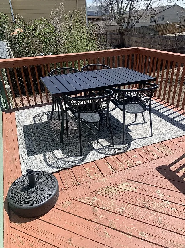 Outdoor Metal Dinner Tables On Patio With Black Metal Chairs