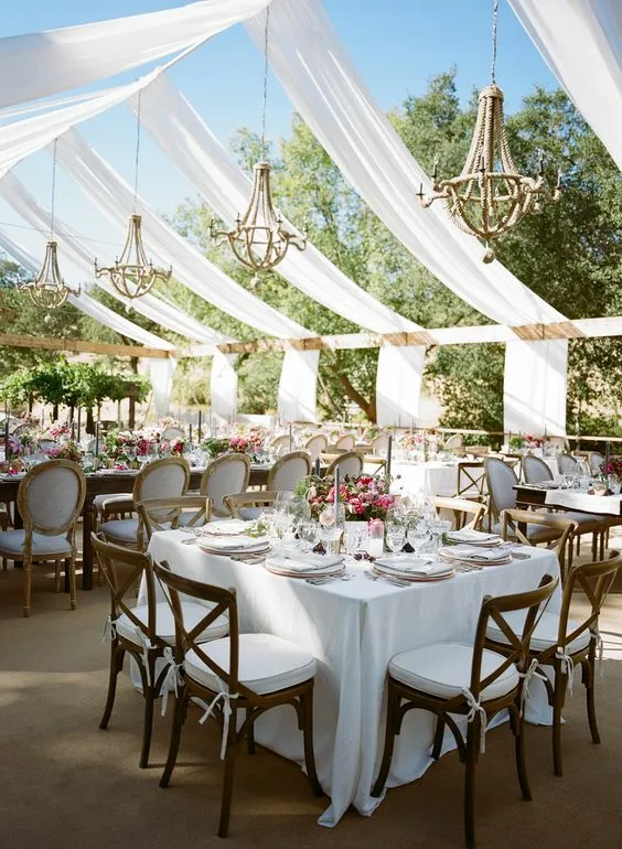 Square Dinner Table White Tablecoth Outdoors With Wooden Chairs