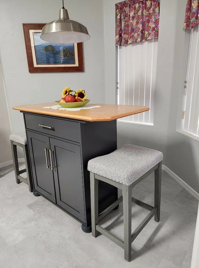 Island With Dining Table Gray Painted With Metal Handle Doors And Cusioned Pull Out Chairs