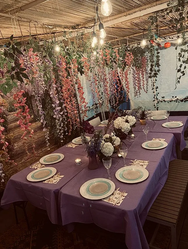 Purple Dining Tables With Hanging Floral Decorations