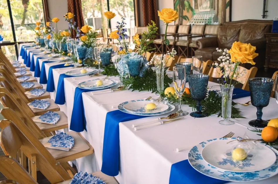 Tablescape Ideas For Summer White Tablecloth On Long Table With Yellow Flower Plants Centerpiece