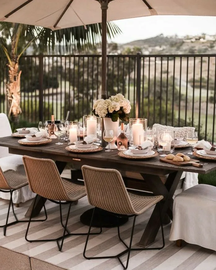 Outdoor Dinner Wood Table With Candles And Flower Vase Centerpiece