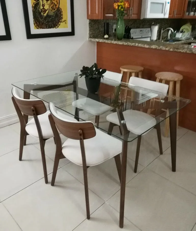 Glass Top Dining Table Elegant And Sleek Brown Painted Metal Design With White Cusioned Chairs