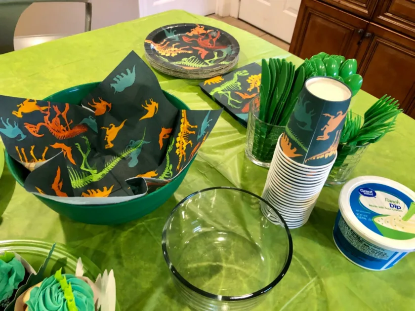 Colorful Napkins Plates Dinosaur Bones Print Closeup Green Utensils Top Angle View Museum Birthday Party